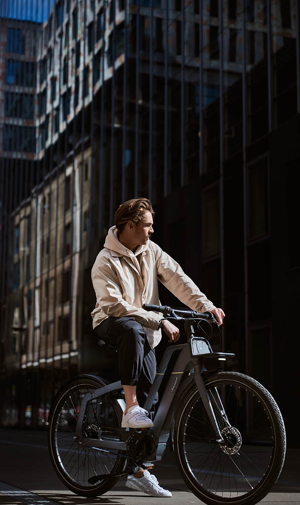 A man riding his Noord bike in an urban environment